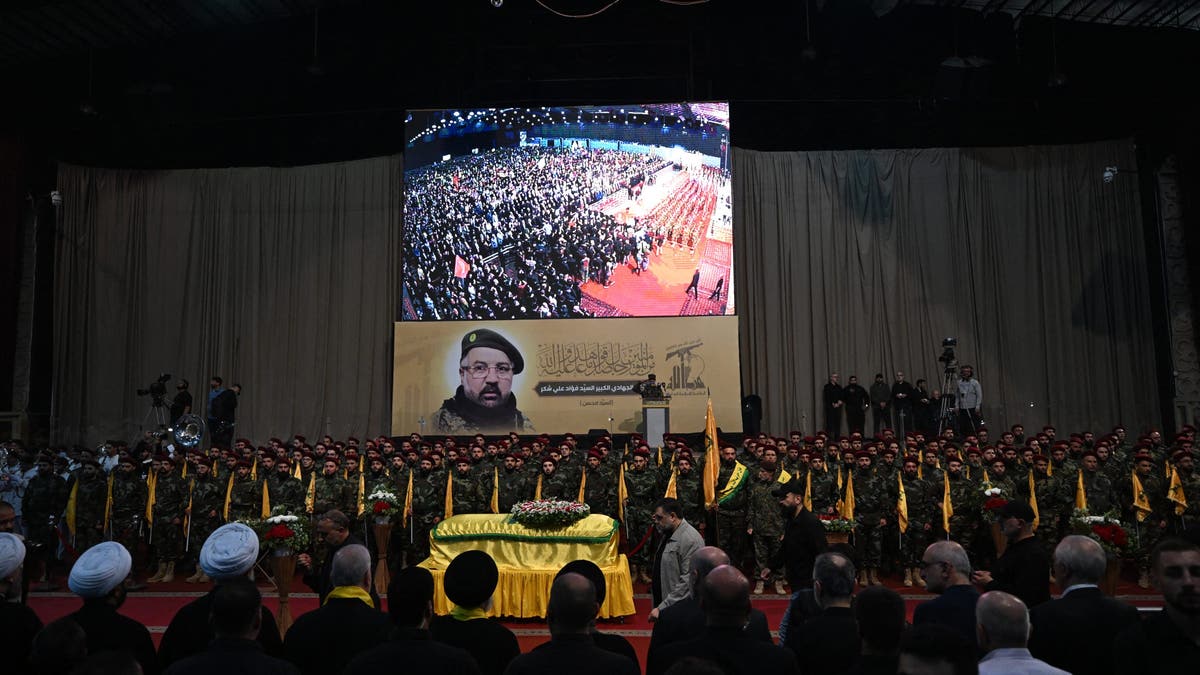 Combatientes de Hezbolá y dolientes asisten al funeral del comandante asesinado Fuad Shukr en los suburbios del sur de Beirut el 1 de agosto de 2024. Hezbolá el 1 de agosto lamentó la muerte de Shukr, cuyo cuerpo fue recuperado de los escombros de un ataque israelí del 30 de julio en el sur de Beirut que también mató a cinco civiles, tres mujeres y dos niños, e hirió a docenas, según el Ministerio de Salud del Líbano, mientras aumentaban los temores de un conflicto más amplio en la región. 