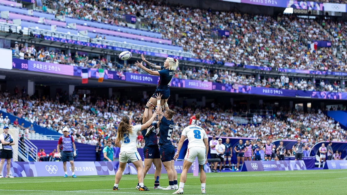 Sammy Sullivan is lifted up by his teammates during a sevens rugby match