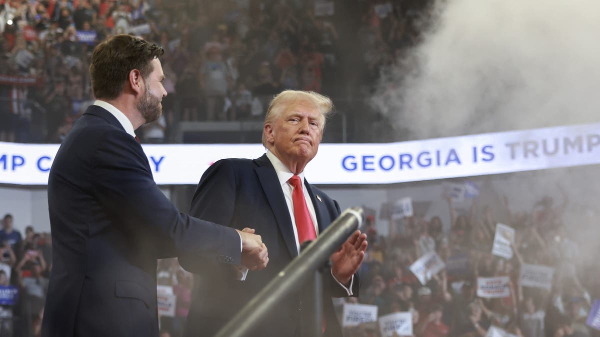 Republican presidential nominee Donald Trump takes the stage with his vice presidential running mate, Sen. JD Vance, during a campaign rally at the Georgia State University Convocation Center in Atlanta on Aug. 3, 2024.
