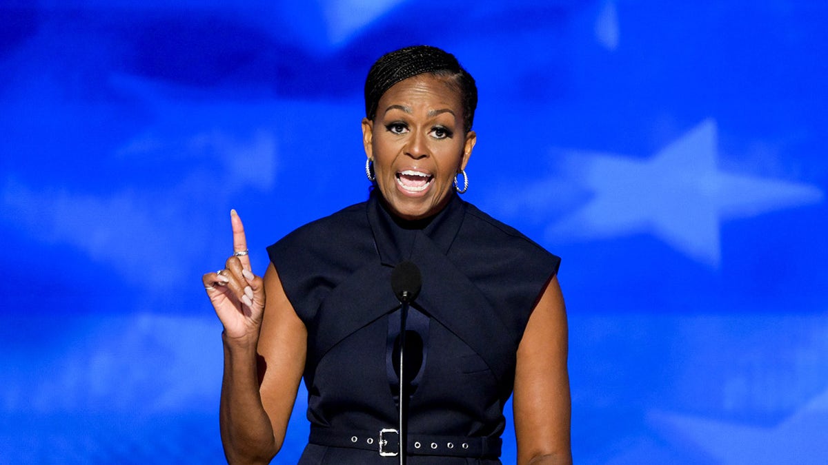 Michelle Obama raises pointer digit  during DNC speech