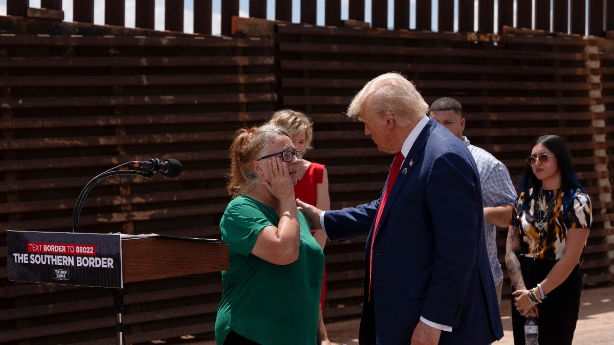 Republican presidential candidate and former President Donald Trump consoles Patty Morin