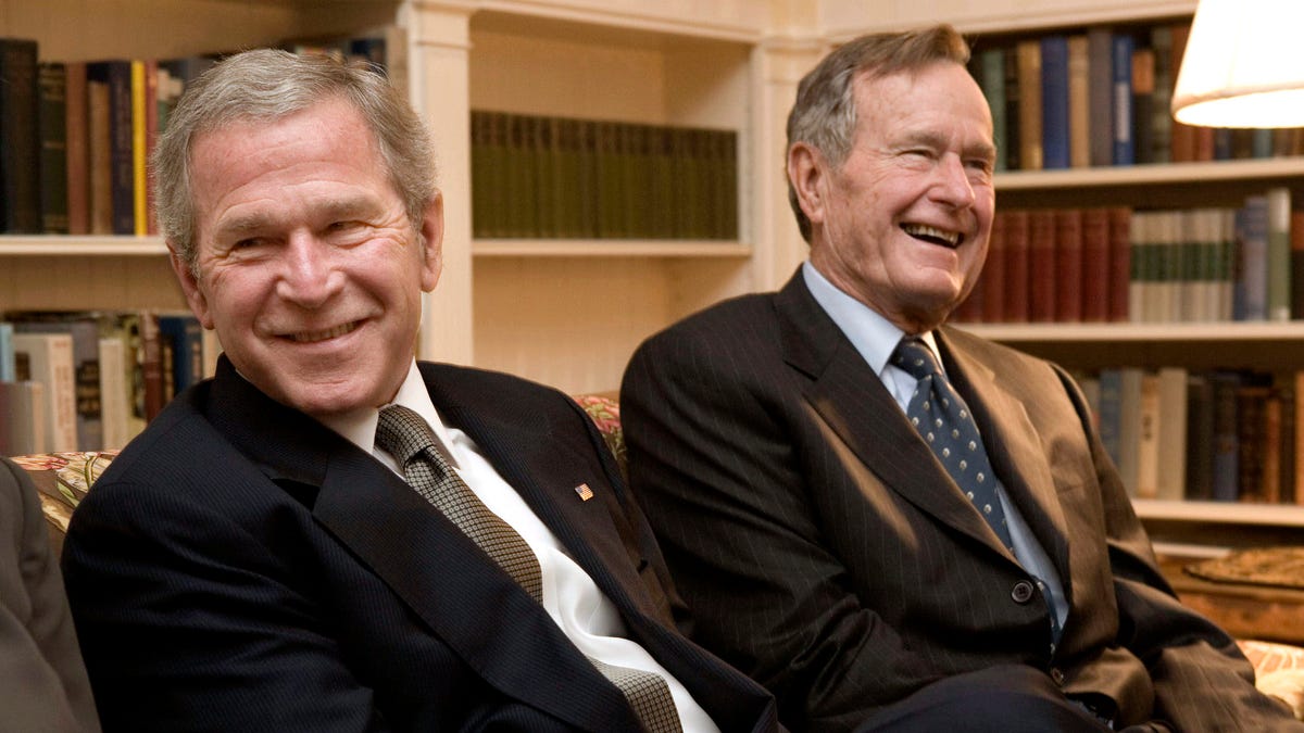 George W. Bush, left, and his father, George H.W. Bush.