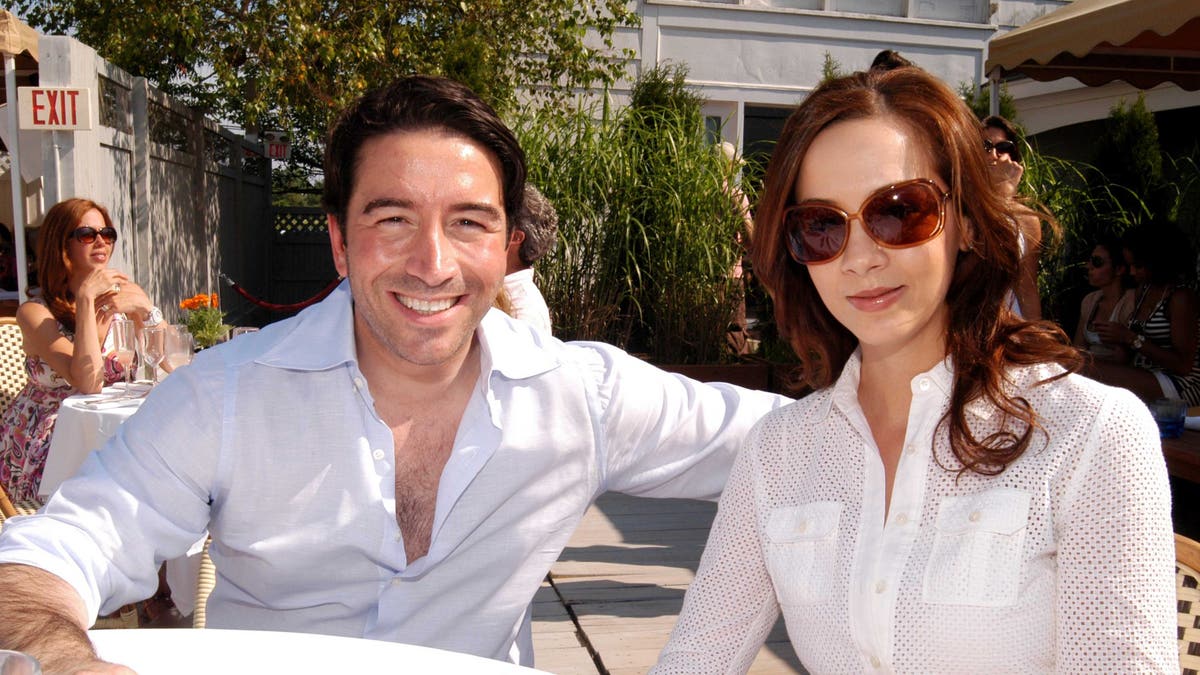 Salvatore Strazzullo and Jodie Strazullo smile at a cafe table in the Hamptons