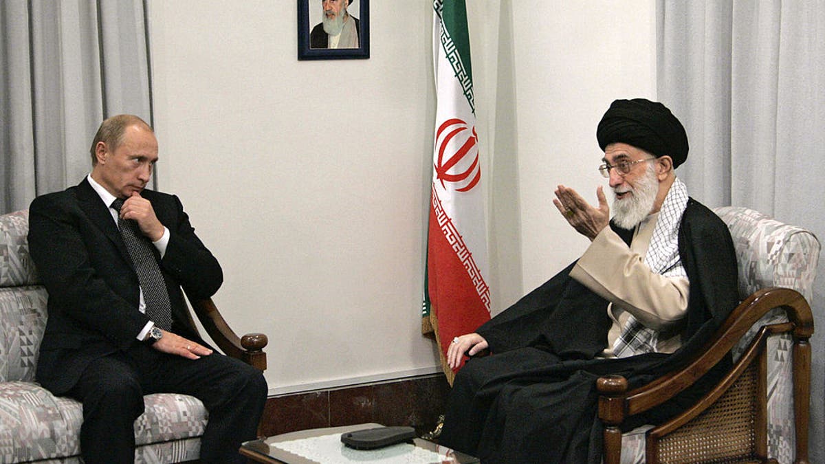 A picture made available 17 October 2007 shows Russian President Vladimir Putin (L) meeting with Iranian supreme leader Ayatollah Ali Khamenei (R) in Tehran, 16 October 2007. On the wall is a portrait of the late Iranian revolutionary founder Ayatollah Ruhollah Khomeini. 