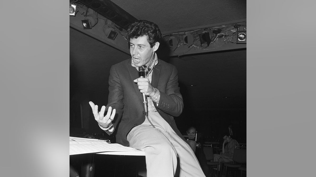 Eddie Fisher on stage performing.