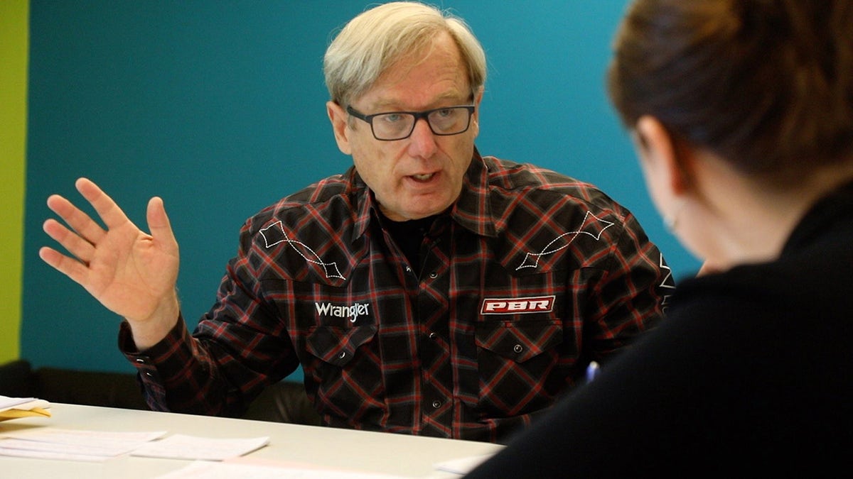 Steve Pankey in a plaid shirt talking to someone off camera