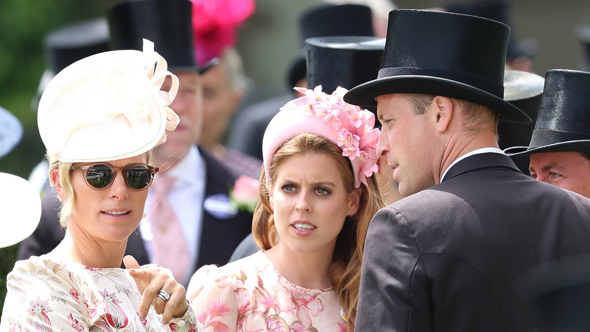 Zara Tindall wearing sunglasses standing next to Princess Beatrice and Prince William outdoors.