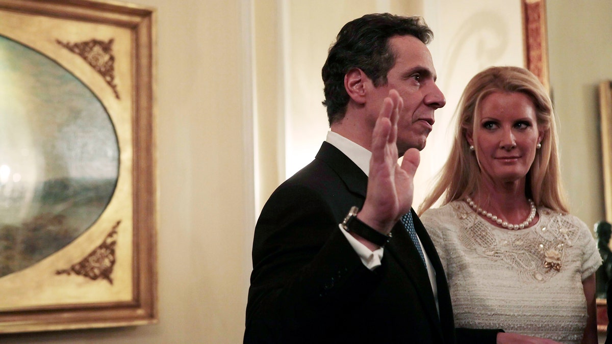 Andrew Cuomo is sworn in as governor with Sandra Lee by his side