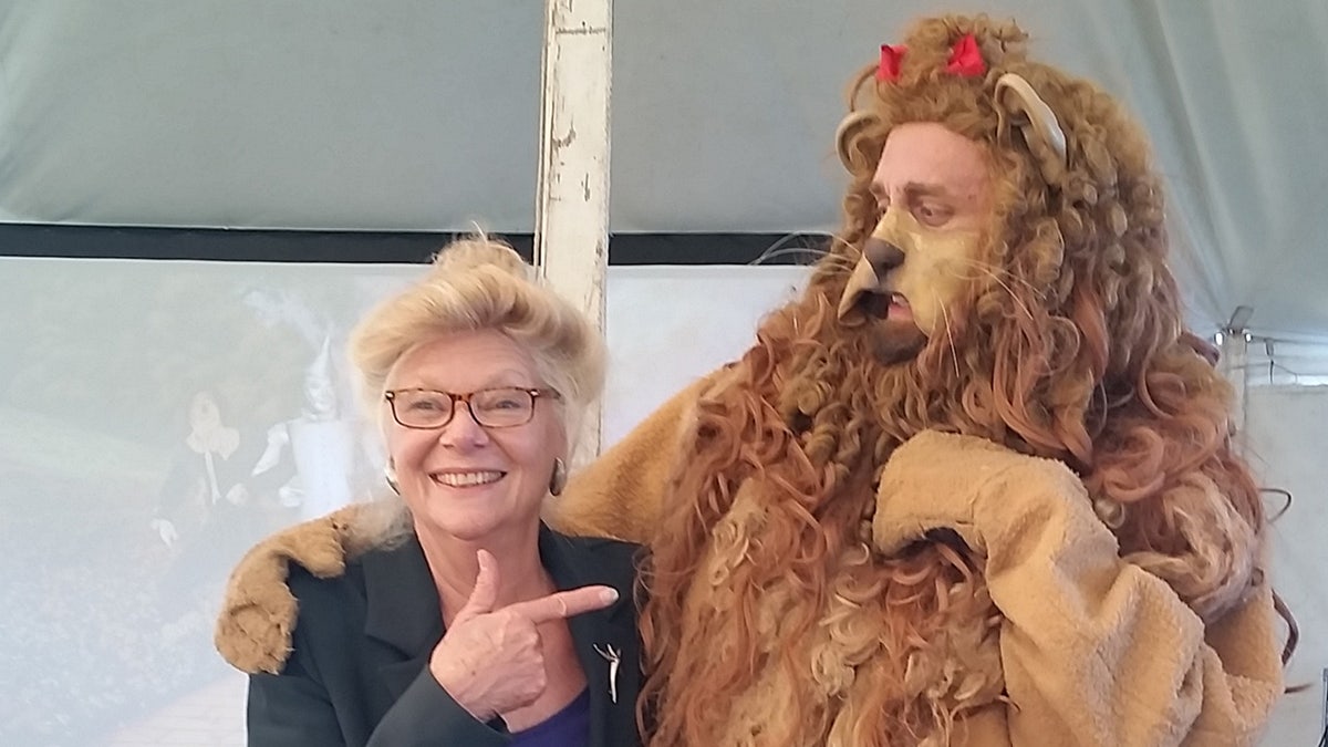 Jane Lahr posing as someone dressed as the Cowardly Lion