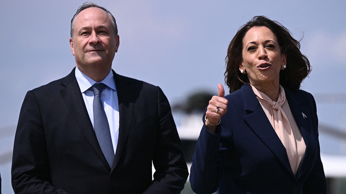 La vicepresidenta de EE.UU. y candidata demócrata a la presidencia en 2024, Kamala Harris, y el segundo caballero Doug Emhoff saludan al subir al Air Force Two