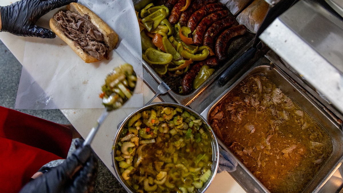 Giardiniera is scooped onto an Italian beef sandwich at Mr. Beef, a restaurant located in the River North neighborhood of Chicago that has been made famous by the television series "The Bear."