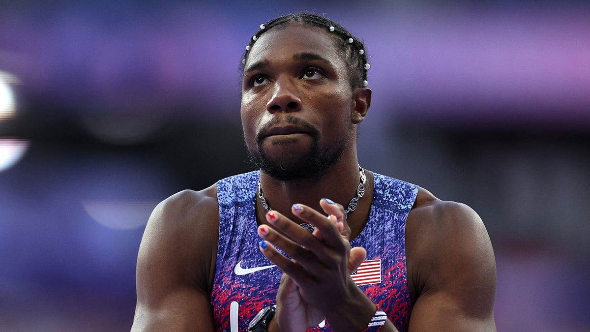 Noah Lyles looks on