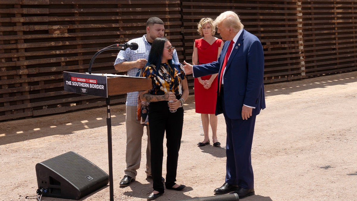 Republican presidential candidate former President Donald Trump comforts Alexis Nungaray, mother of Jocelyn Nunagaray, who was allegedly murdered by illegal immigrants, at the U.S.-Mexico border fence on August 22, 2024 south of Sierra Vista, Arizona .