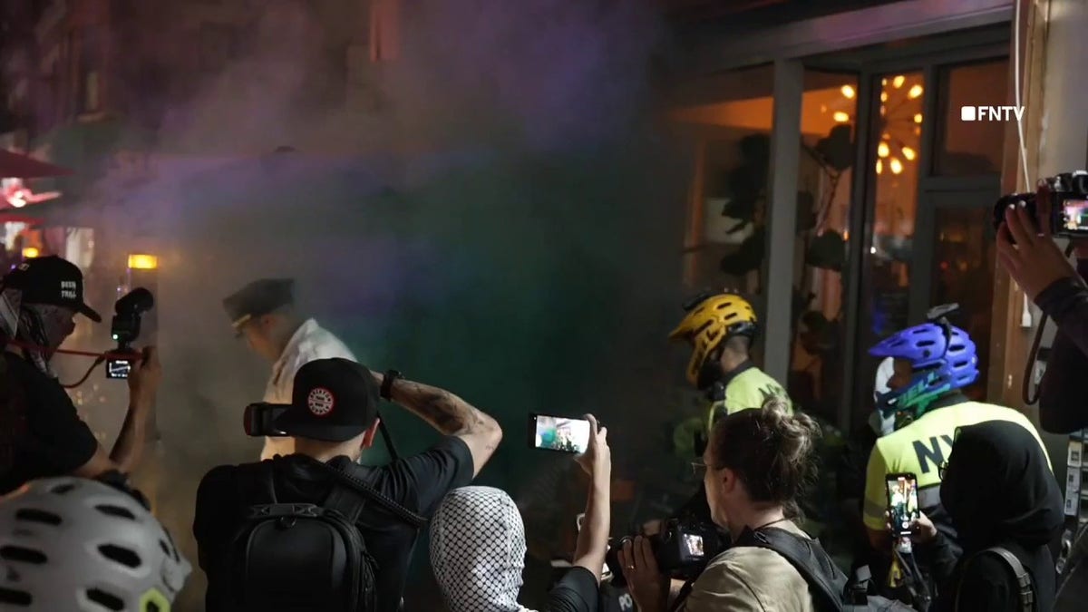 Protesters outside Harris' event in Harlem, New York