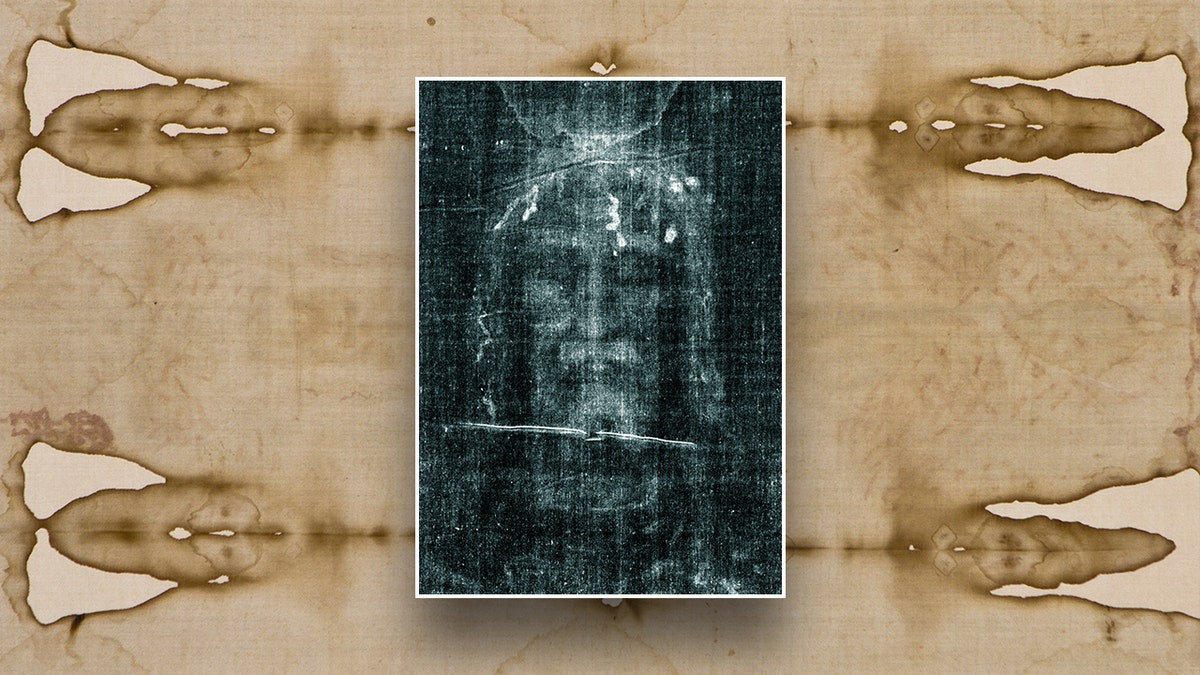 Negative image of the Shroud of Turin displayed with the original shroud in the background