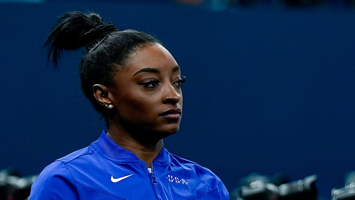 Simone Biles looks on