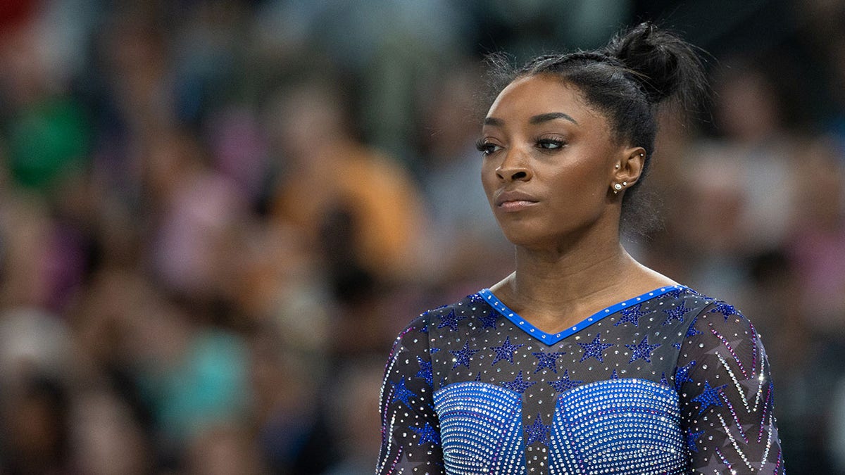 Simone Biles looks on