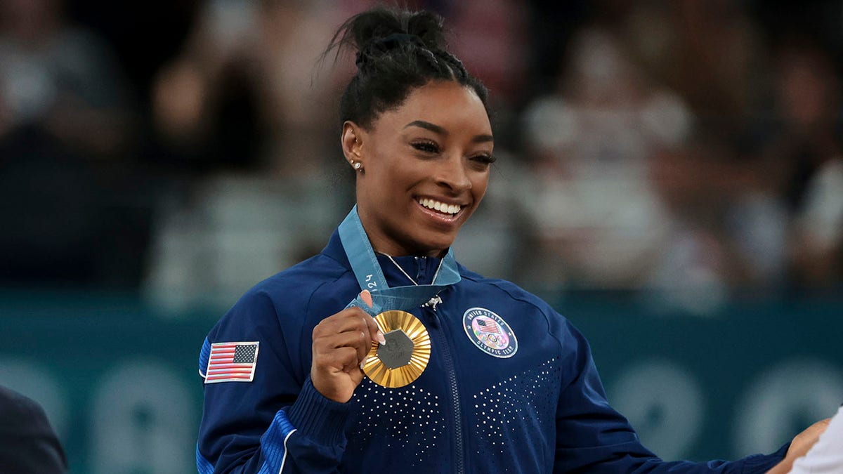 Gold medallist Simone Biles of Team USA poses on the podium during the medal ceremony for the Artistic Gymnastics Women's All-Around Final on day six of the Paris 2024 Olympic Games at the Bercy Arena on August 1, 2024 in Paris.