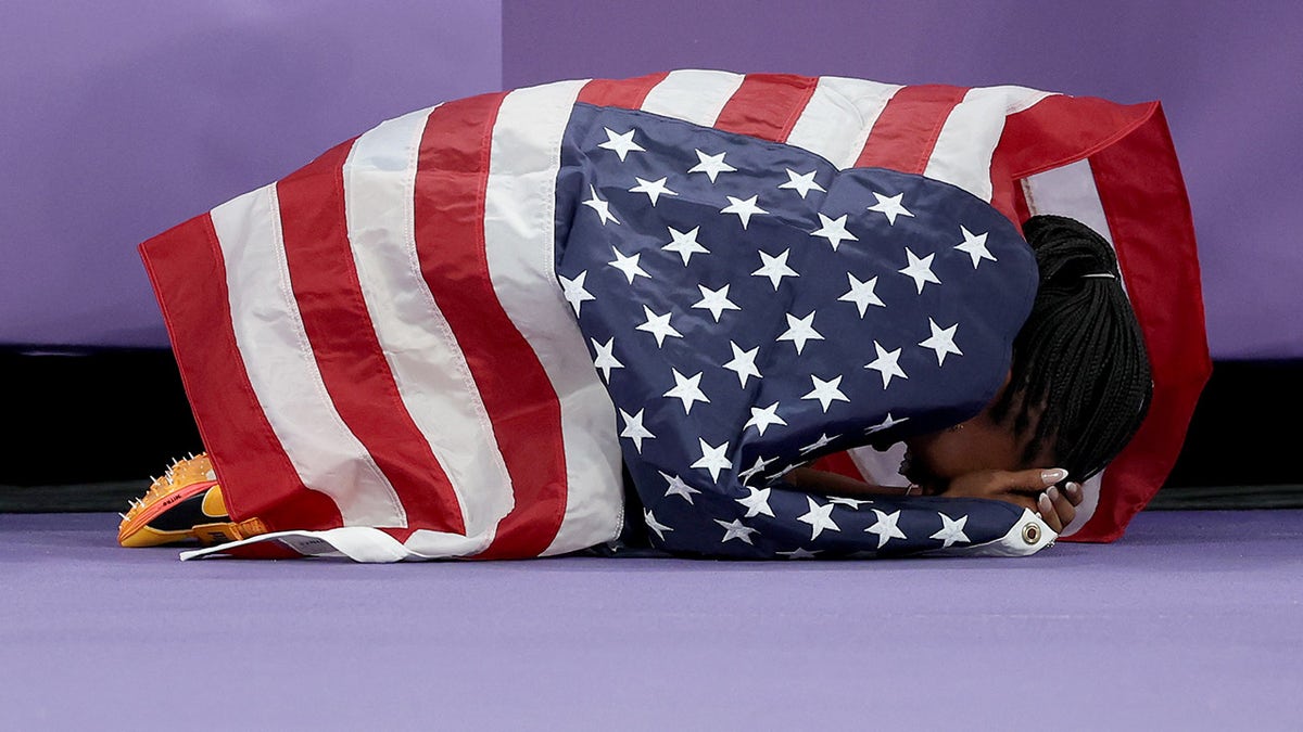 Tara Davis-Woodhall wrapped in American flag