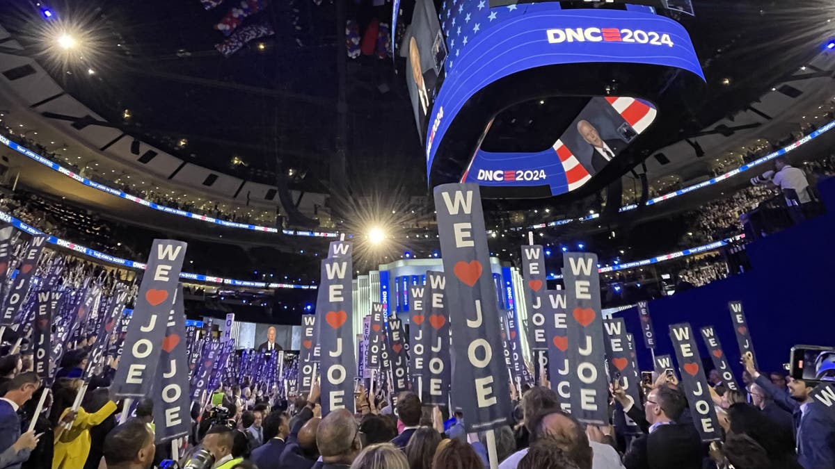 As President Biden speaks at the Democratic National Convention, "We love Joe" Banners fill the United Arena in Chicago, Illinois, on August 19, 2024. 