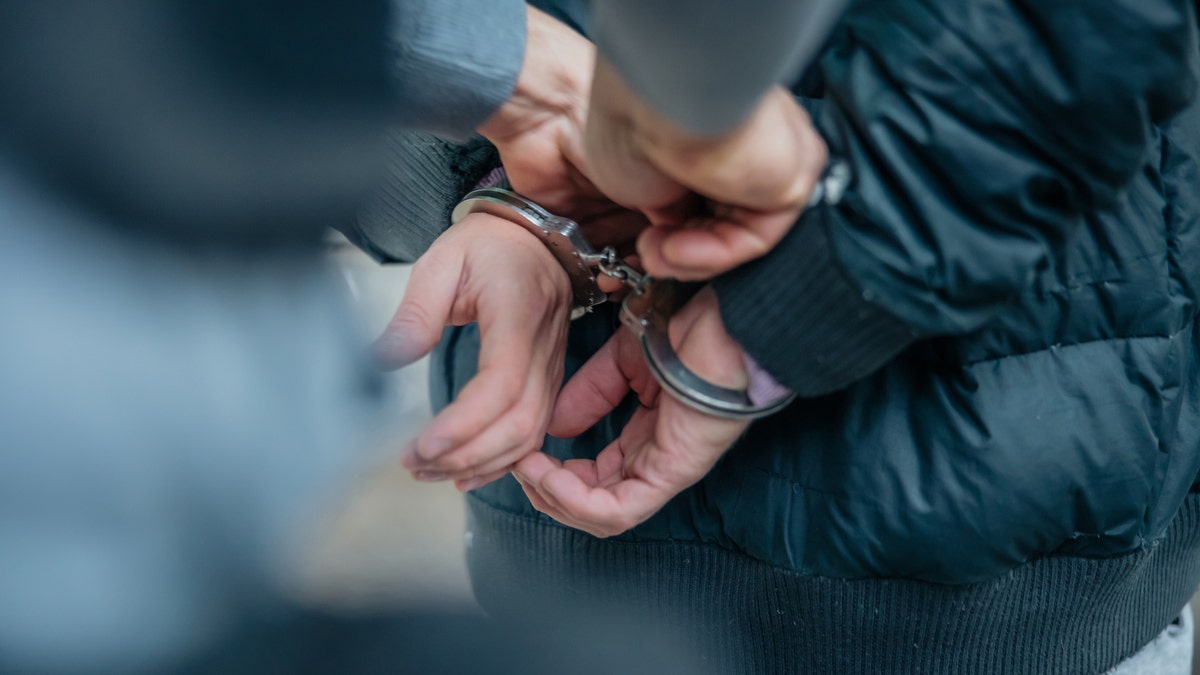 Criminal being put into handcuffs