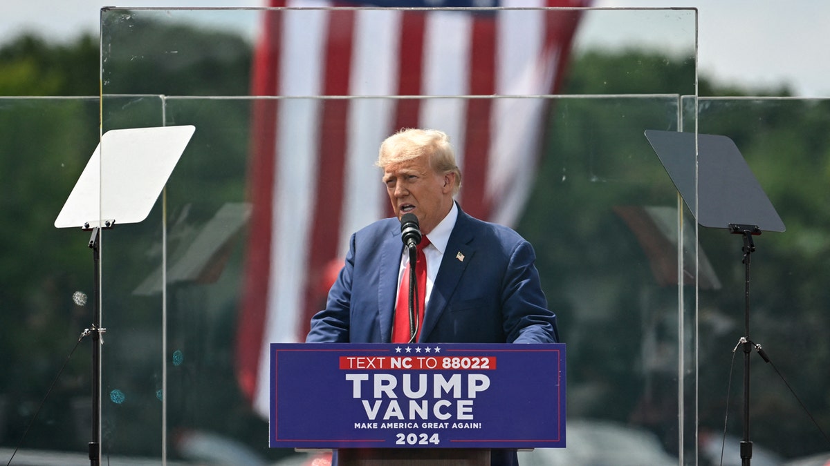 Trump appears in Asheboro, North Carolina, behind bulletproof glass