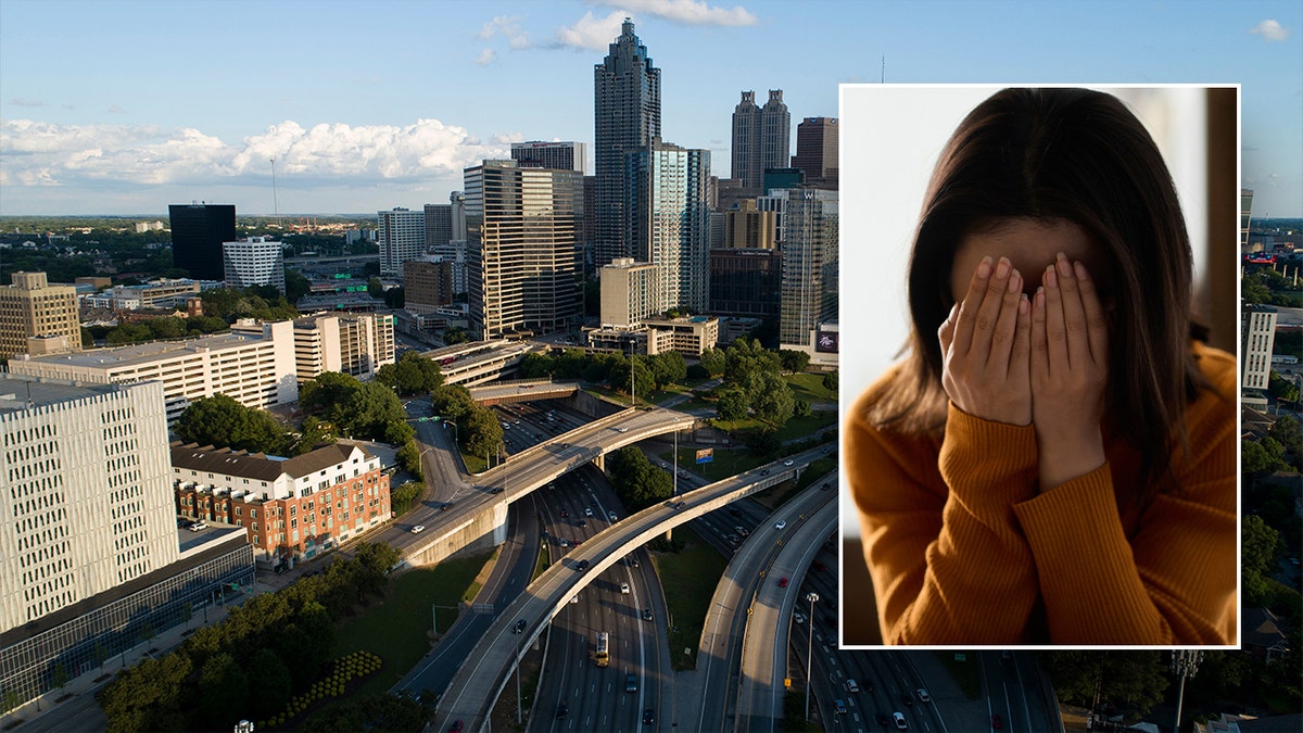 A woman with her hand buried in her hands and Atlanta in the background