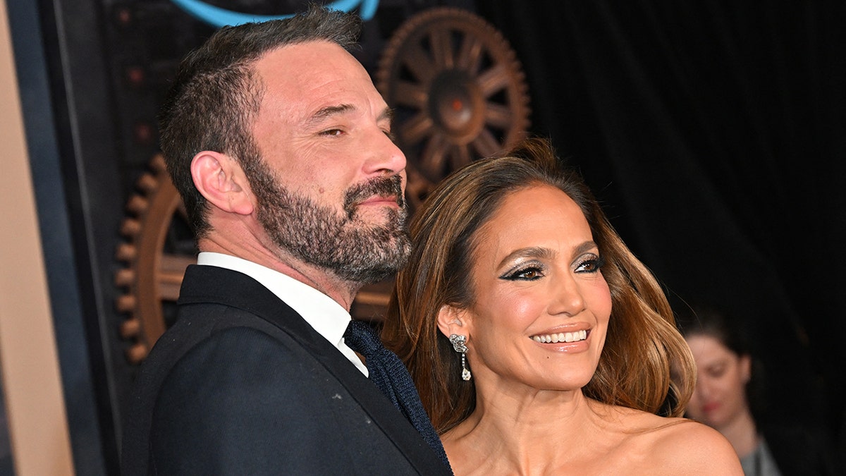 Jennifer Lopez and Ben Affleck smile on the red carpet