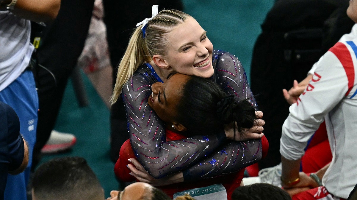 Jade Carey hugs Simone Biles