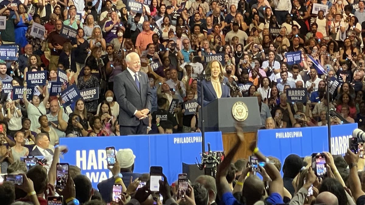 Vice President Kamala Harris (right) and her running mate, Minnesota Gov. Tim Walz, speak in front of a large crowd in Philadelphia, Pennsylvania, on August 6, 2024, as they kick off a battleground state campaign swing