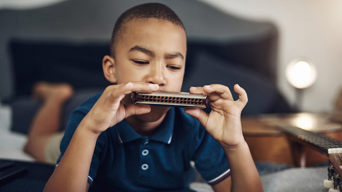 Child playing a harmonica