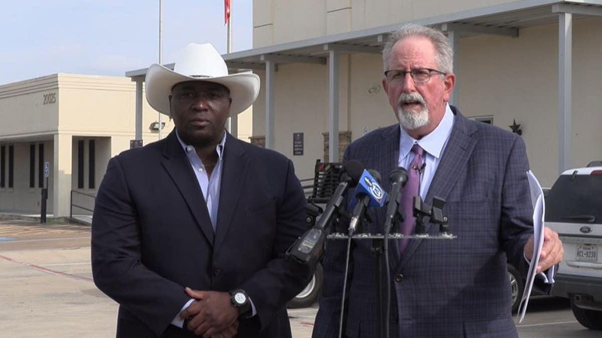 Freddie Douglas, left, stands with attorney Mike Kerensky on Aug. 22 in front of Manvel City Hall.