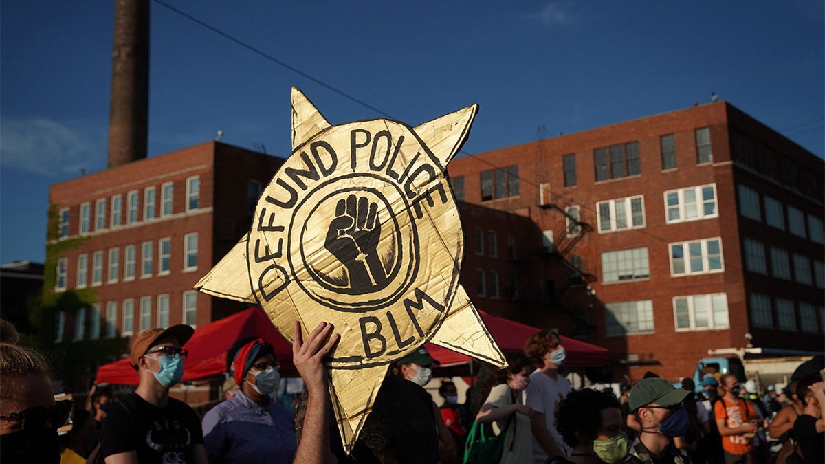 Sign “Defund the Police”