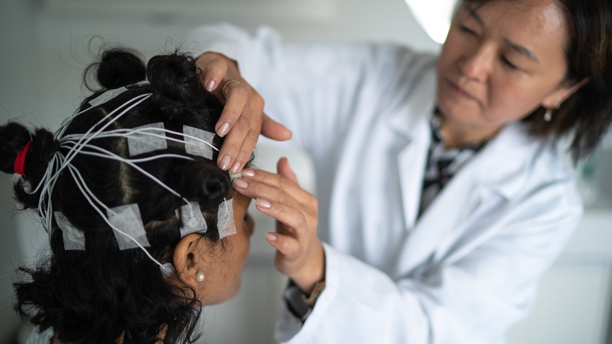 Doctor applying EEG electrodes