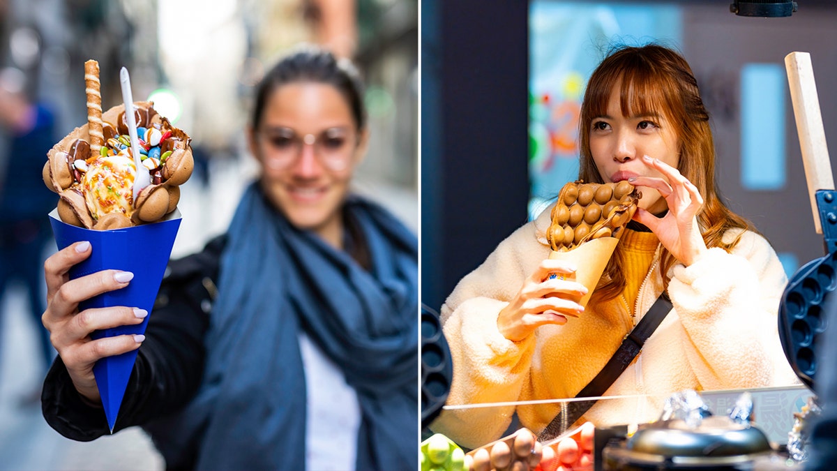 A woman (left) holds a bubble waffle with ice cream and candy in a blue paper bag. Another woman (right) eats a dessert egg waffle.