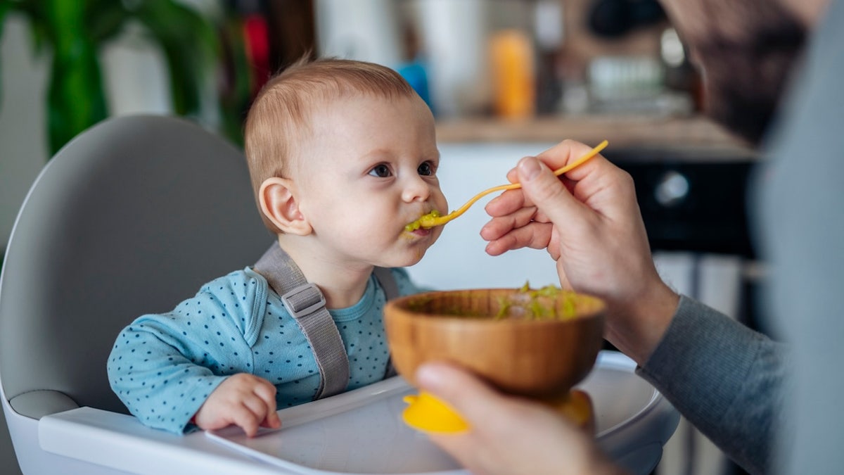 Parents feeding their baby