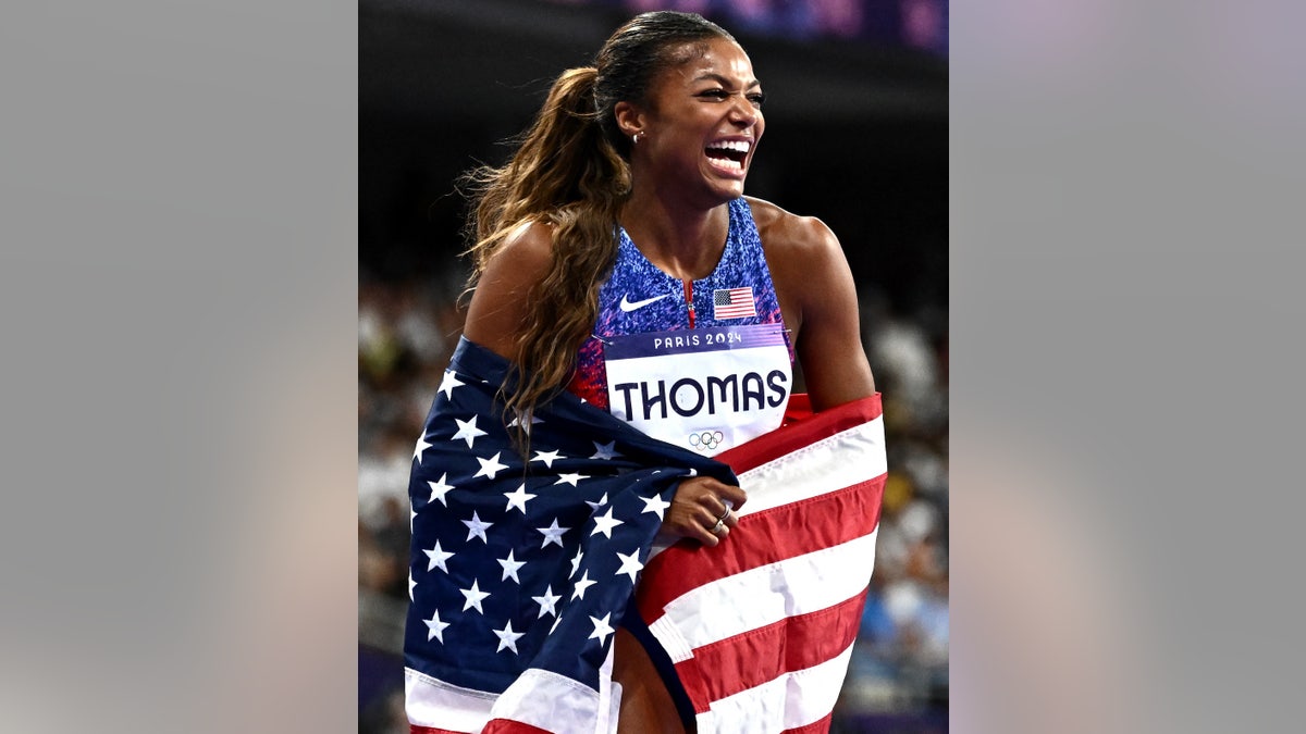 US' Gabrielle Thomas celebrates winning the women's 200m final of the athletics event at the Paris 2024 Olympic Games at Stade de France in Saint-Denis, north of Paris, on August 6, 2024. (Photo by Jewel SAMAD / AFP)