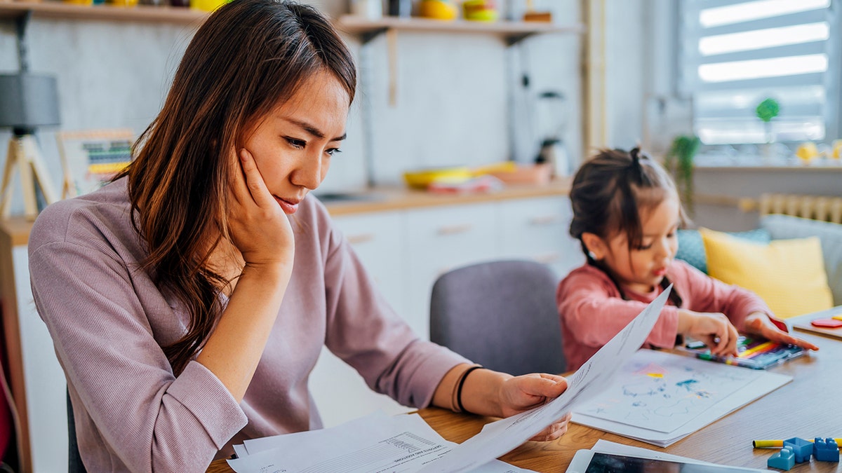 madre estresada revisando sus finanzas