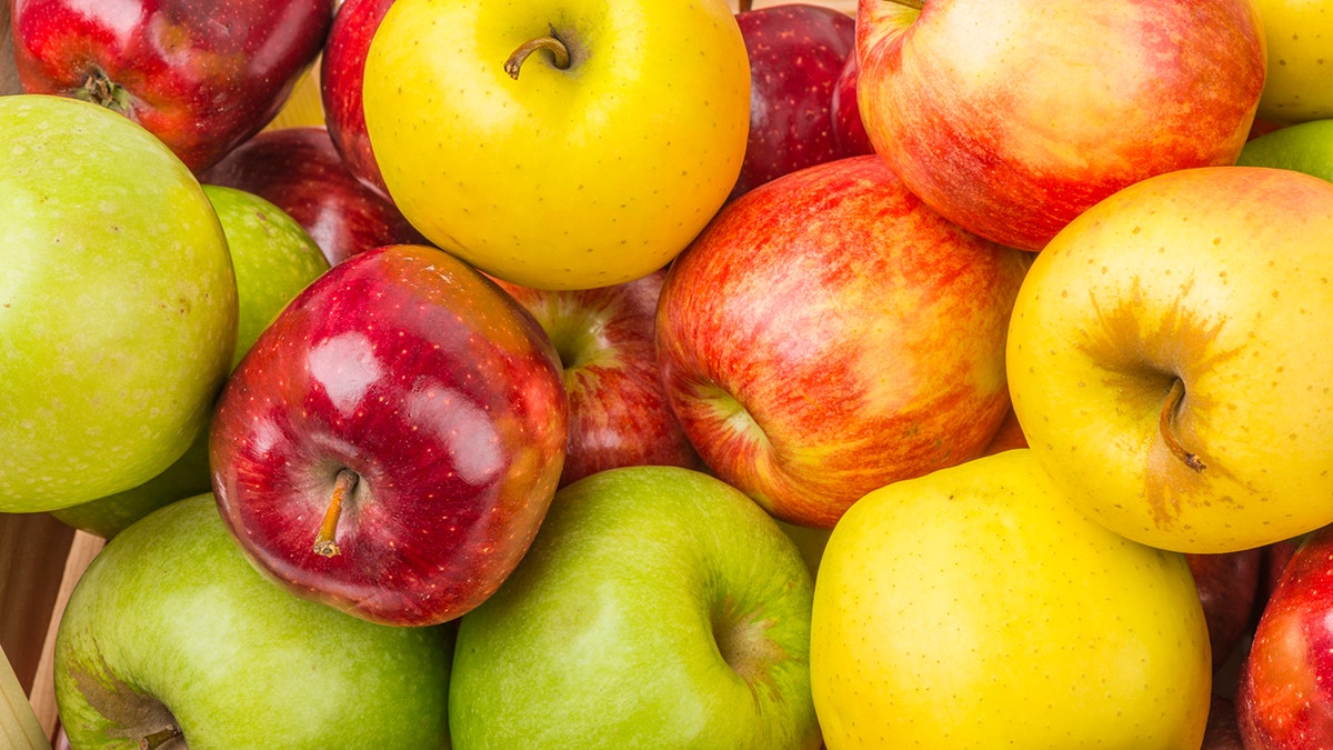 Group of apples in a traditional wooden box.