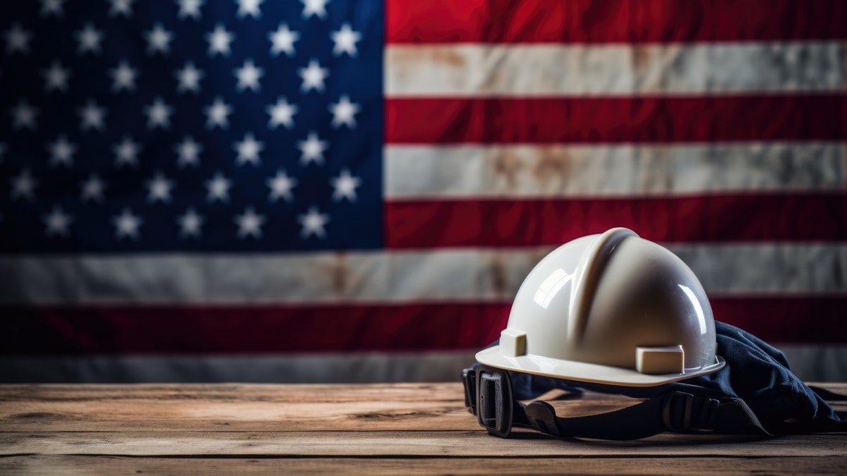 A hard hat with an American flag in the background