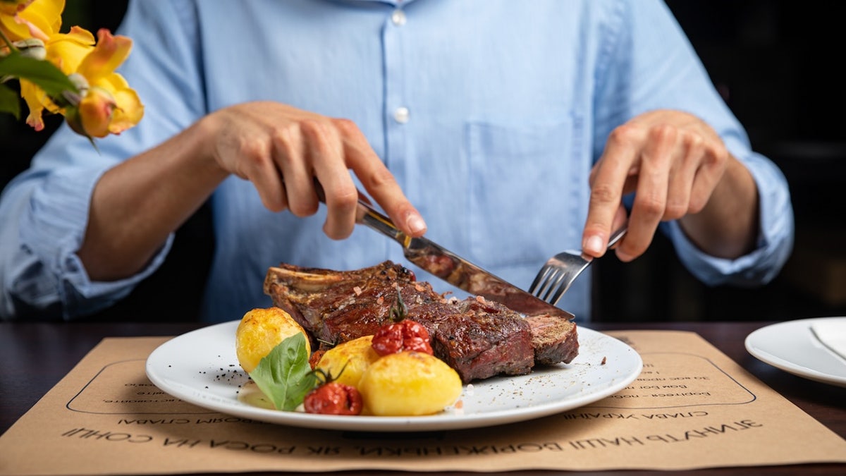 A man eating a steak