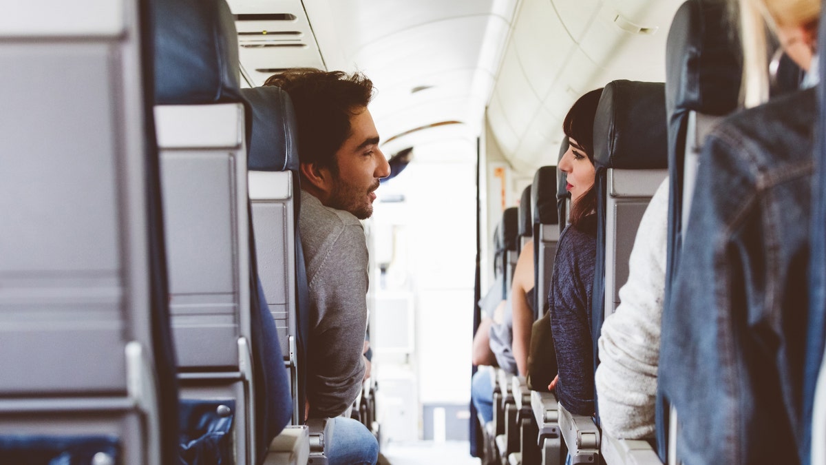 A man and woman on an airplane