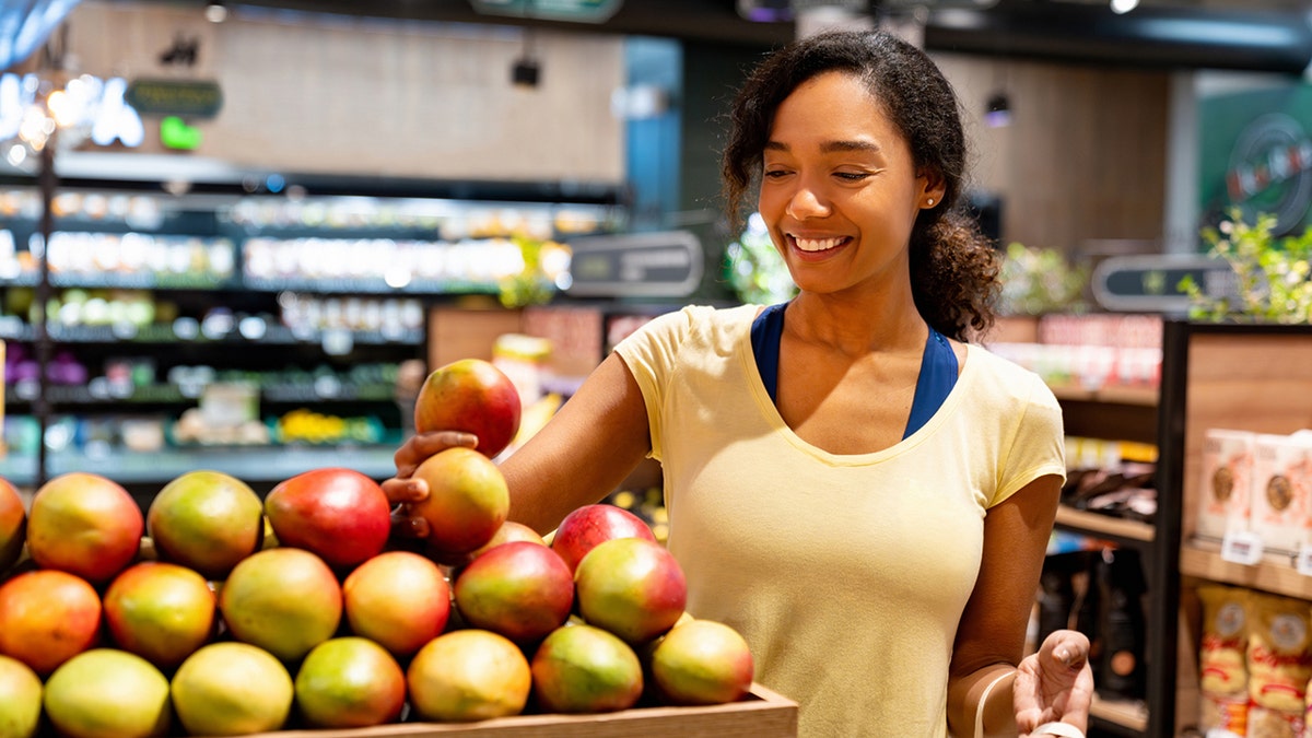 Woman buys mangos