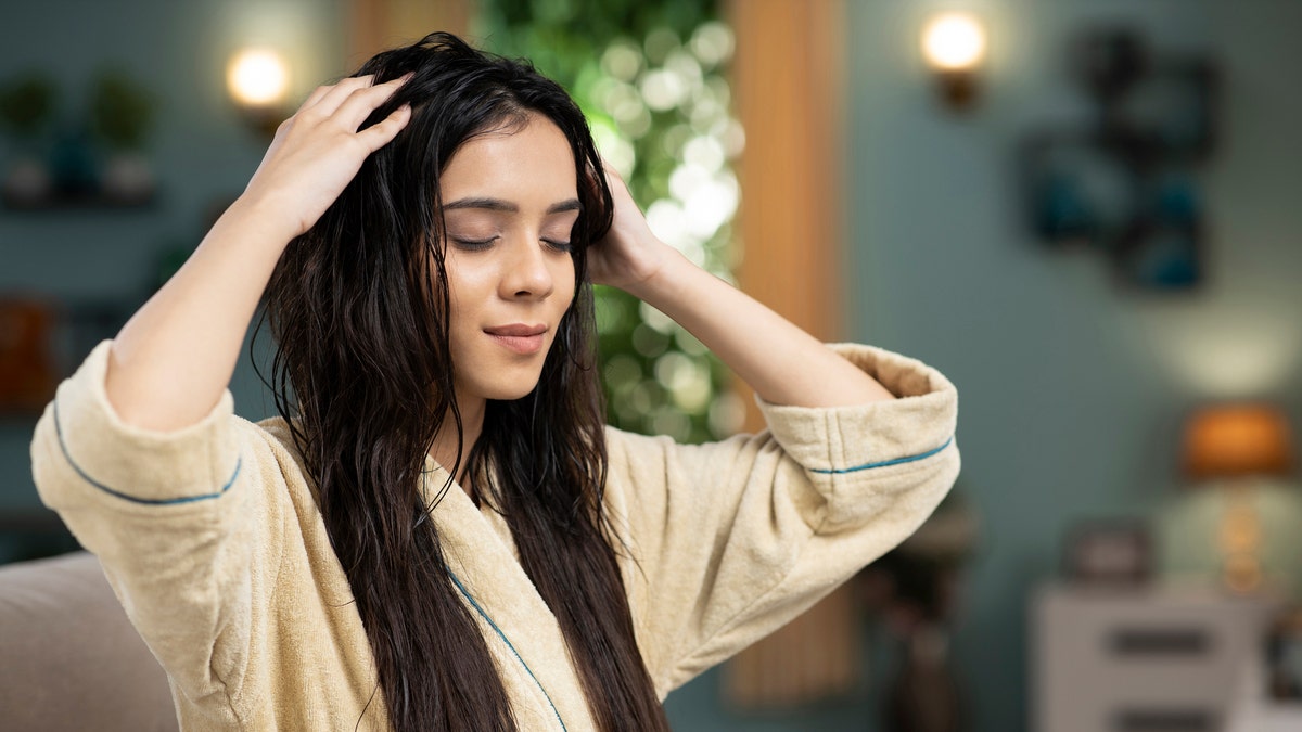 A woman massaging her scalp