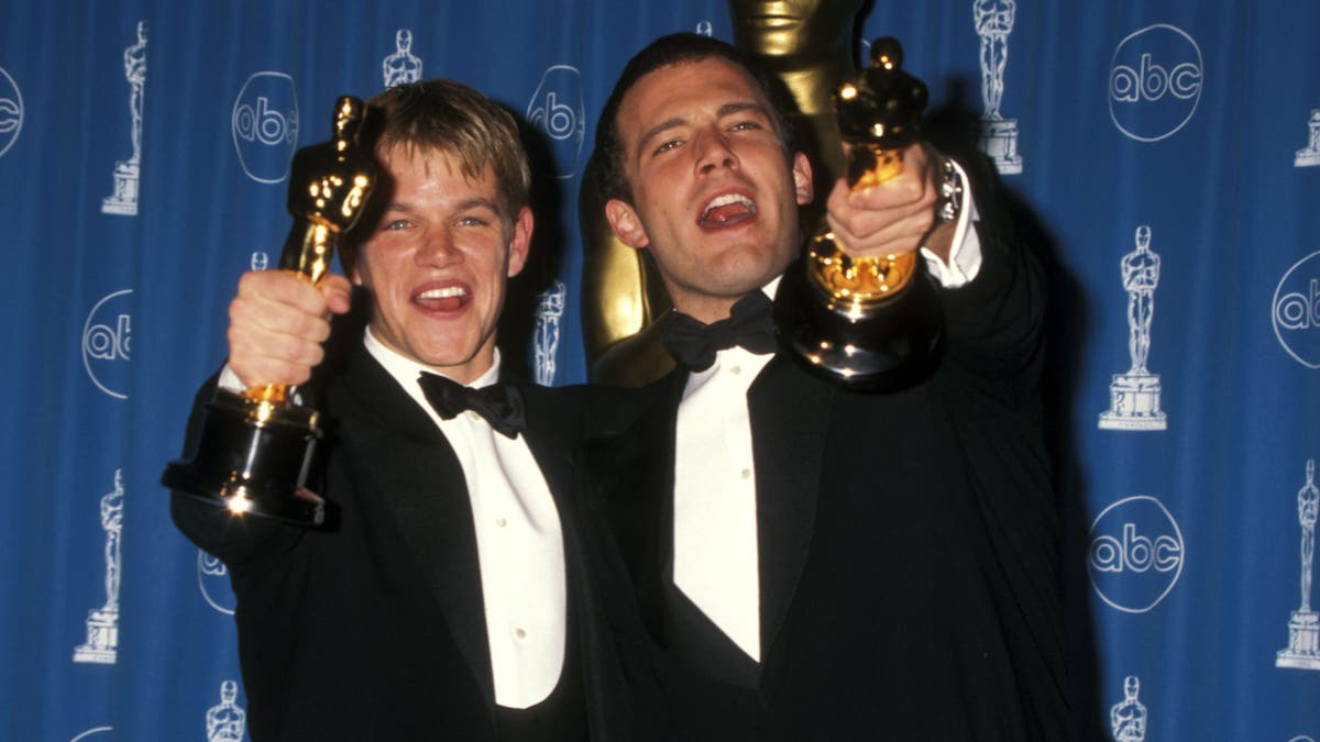 Matt Damon and Ben Affleck holding up Oscars