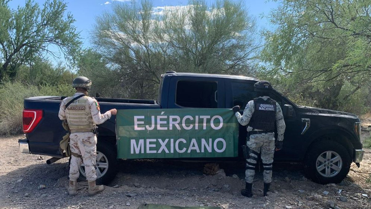 National Guard soldiers investigate the crime scene