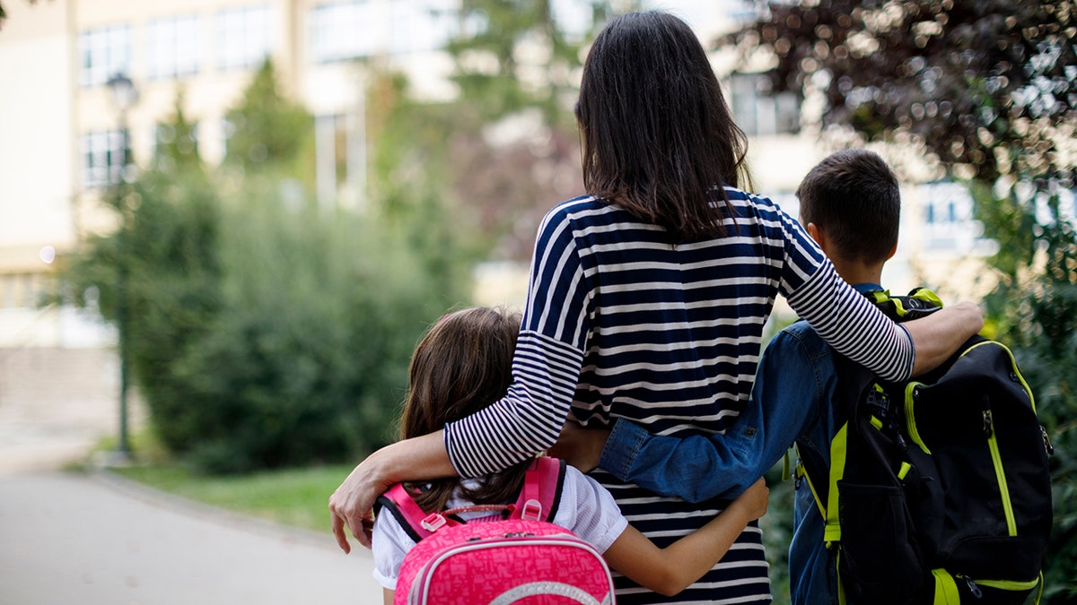 iStock image of mom picking up her kids from school