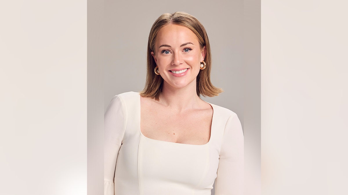 Whitney Leavitt of 'The Secret Lives of Mormon Wives' smiles for a headshot wearing a boxy white top