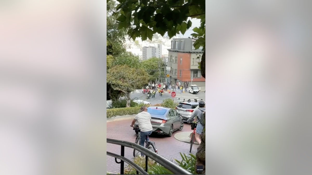 Tourists watch bikers in San Fran