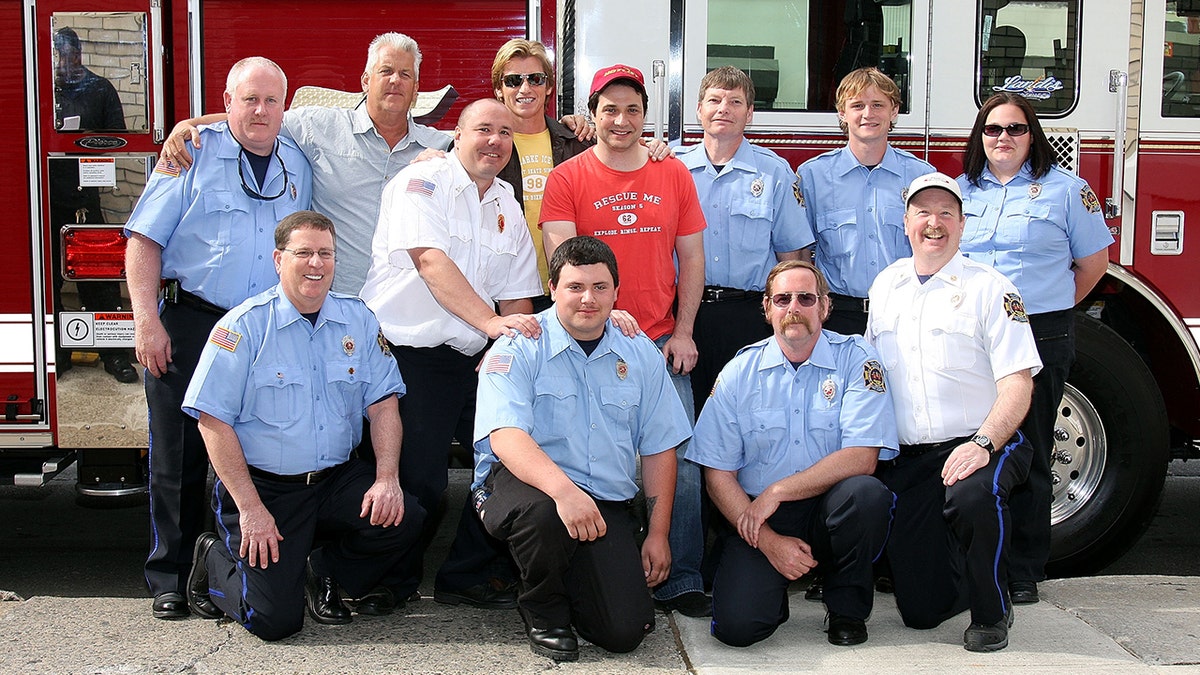 "Rescue Me" actors Denis Leary, Adam Ferrara and Lenny Clarke poses amongst firefighters in blue shirts